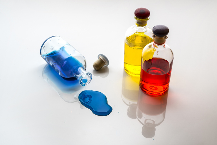 High Angle View Of Colorful Liquids In Bottles On White Background