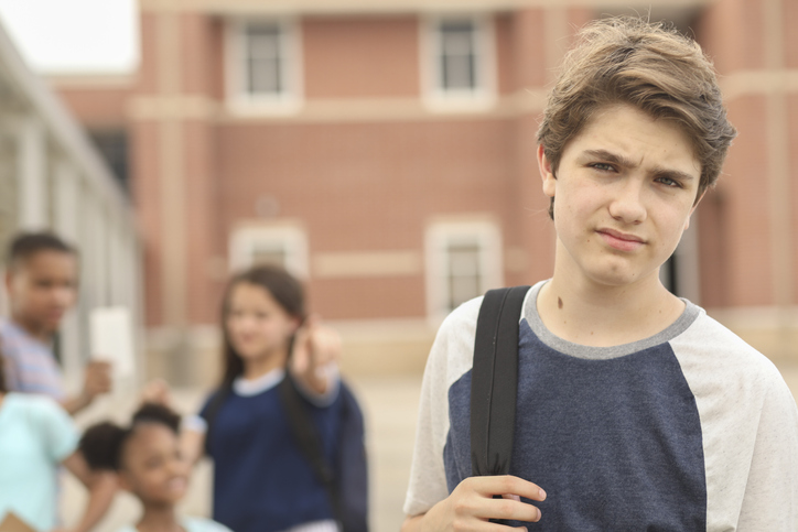 Junior high age boy being bullied at school.