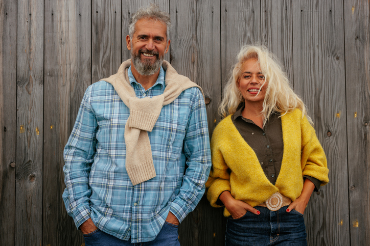 Senior couple outdoors looking at camera.