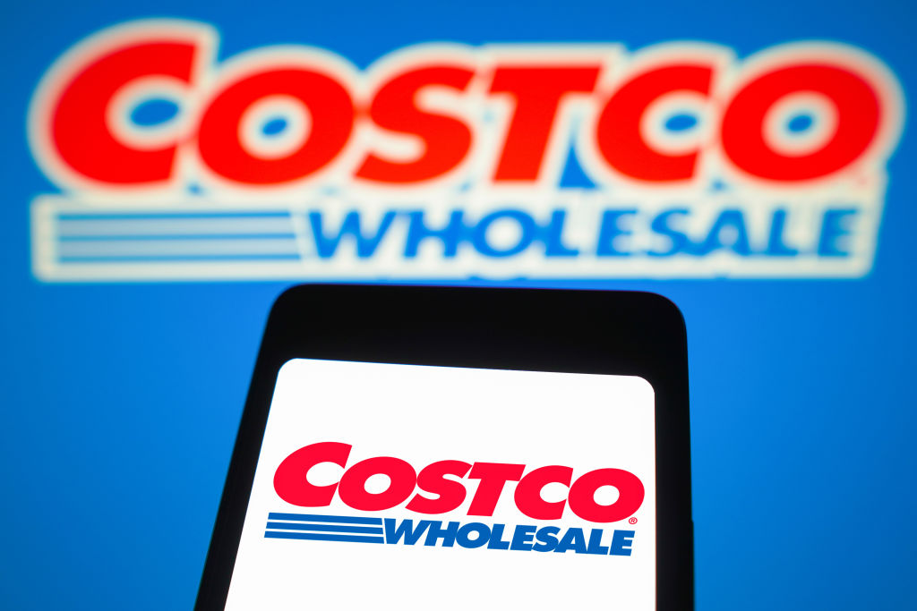 In this photo illustration, the Costco Wholesale logo is...