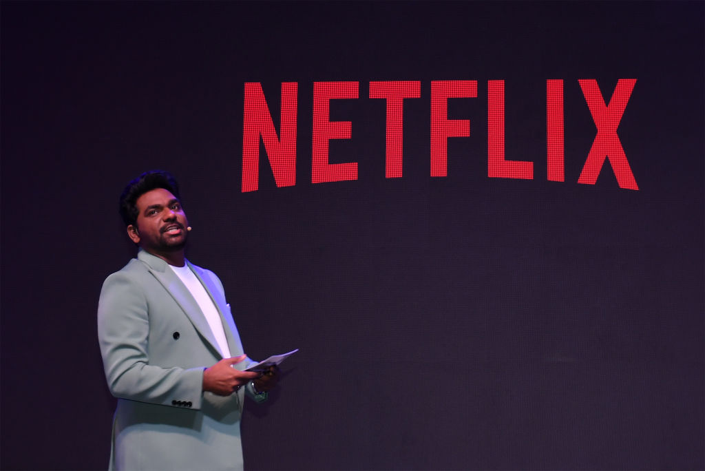 Indian comedian and poet Zakir Khan, stands near the Netflix...