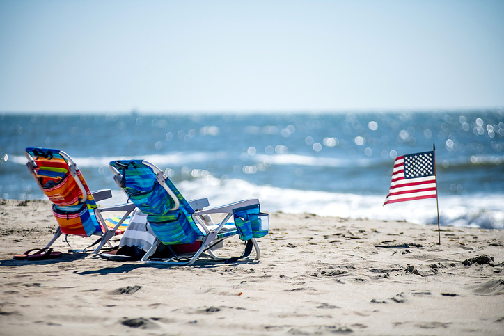 Lounge chairs at the beach with American Flag