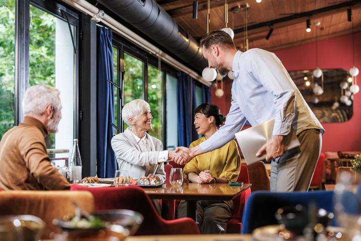 Business meeting at a restaurant with diverse group discussing ideas