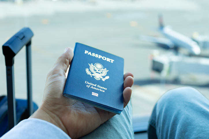 Man holding US passport in his hand and waiting for the immigration.