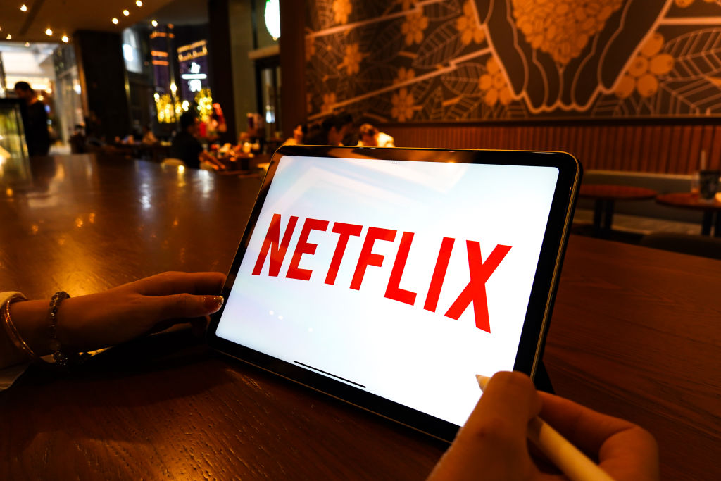 In this photo illustration, a Netflix logo is displayed on...