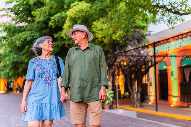 Senior tourist couple talking and walking outdoors