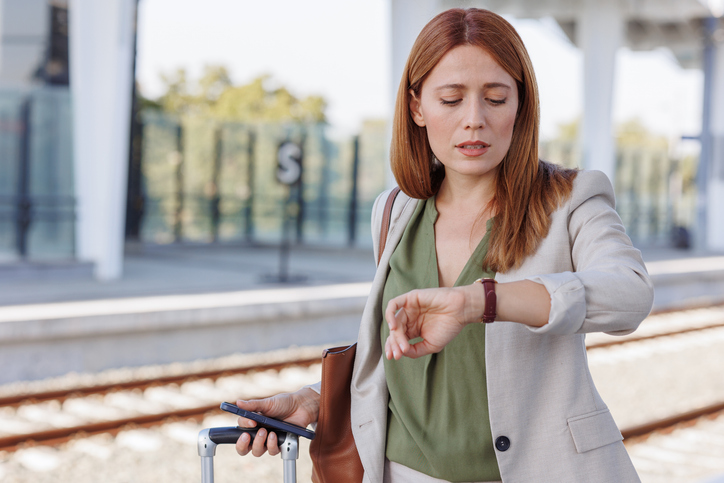 Businesswoman checking the time at the train station