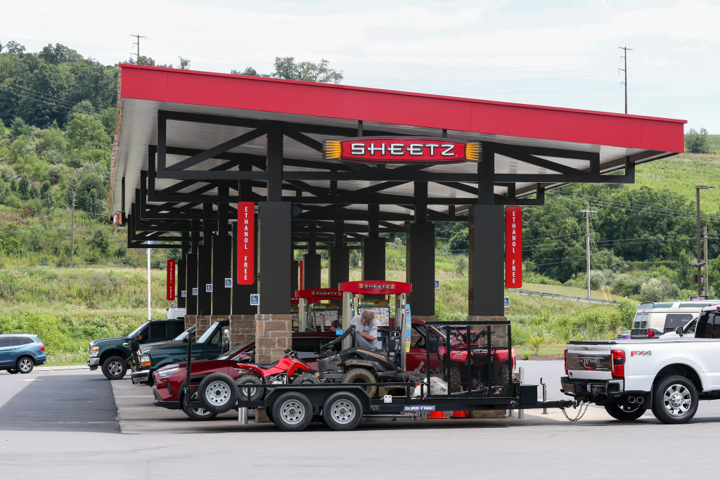 Vehicles are seen at the gas pumps of a Sheetz convenience...