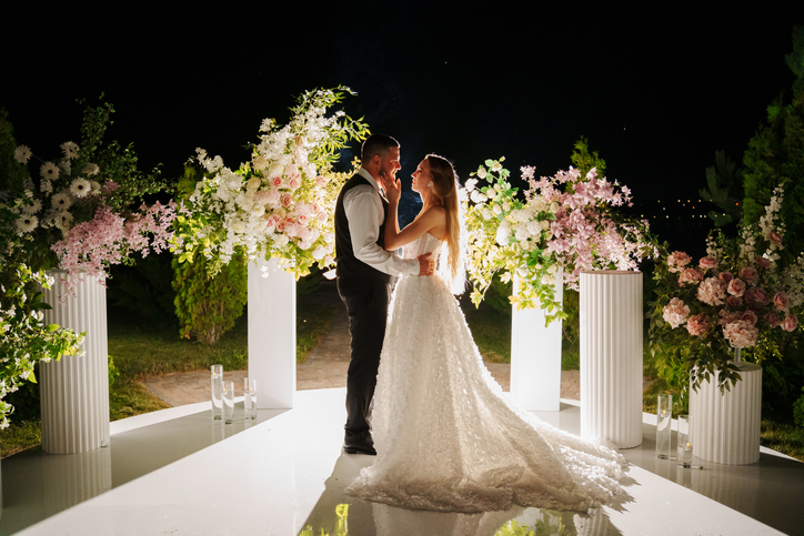 Bride and groom in the night area for the wedding ceremony with flowers.