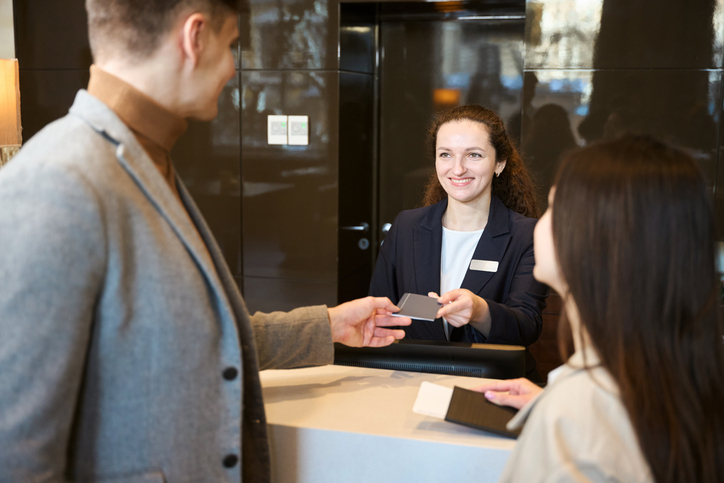 Tourist couple checking into hotel upon arrival
