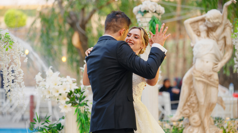 Young bride and groom dancing happily at their wedding ceremony