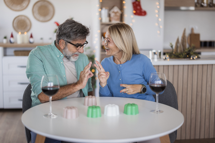 Senior couple sharing a joyful moment playing game at home