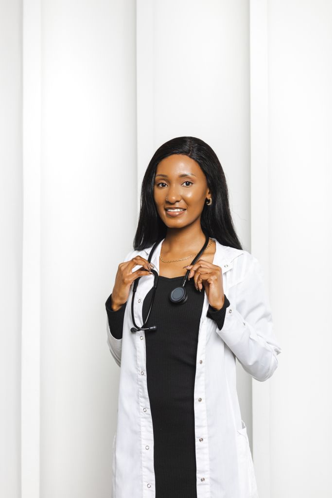 Professional female doctor posing with stethoscope in white coat for medical portrait