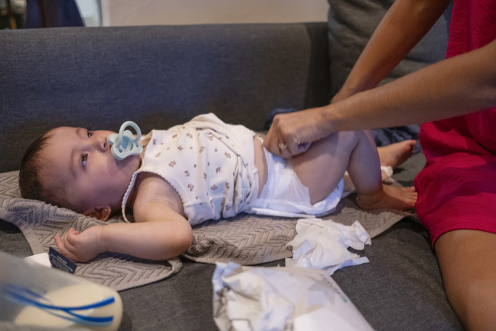 mother changing her baby's nappy