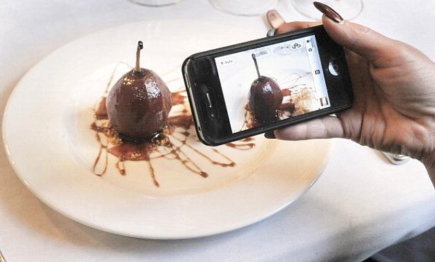 Woman Taking Picture of Food